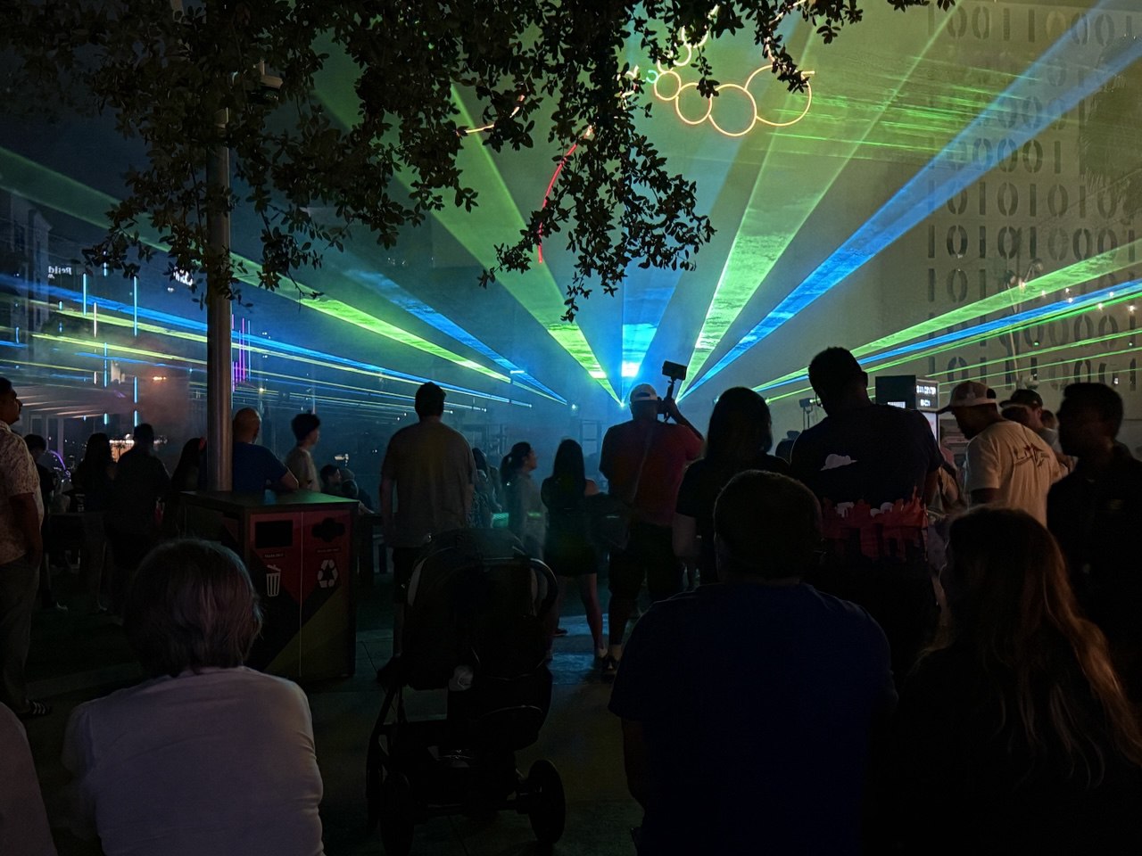 Green and blue lasers with graphic rings projected on the Beacon. families watching