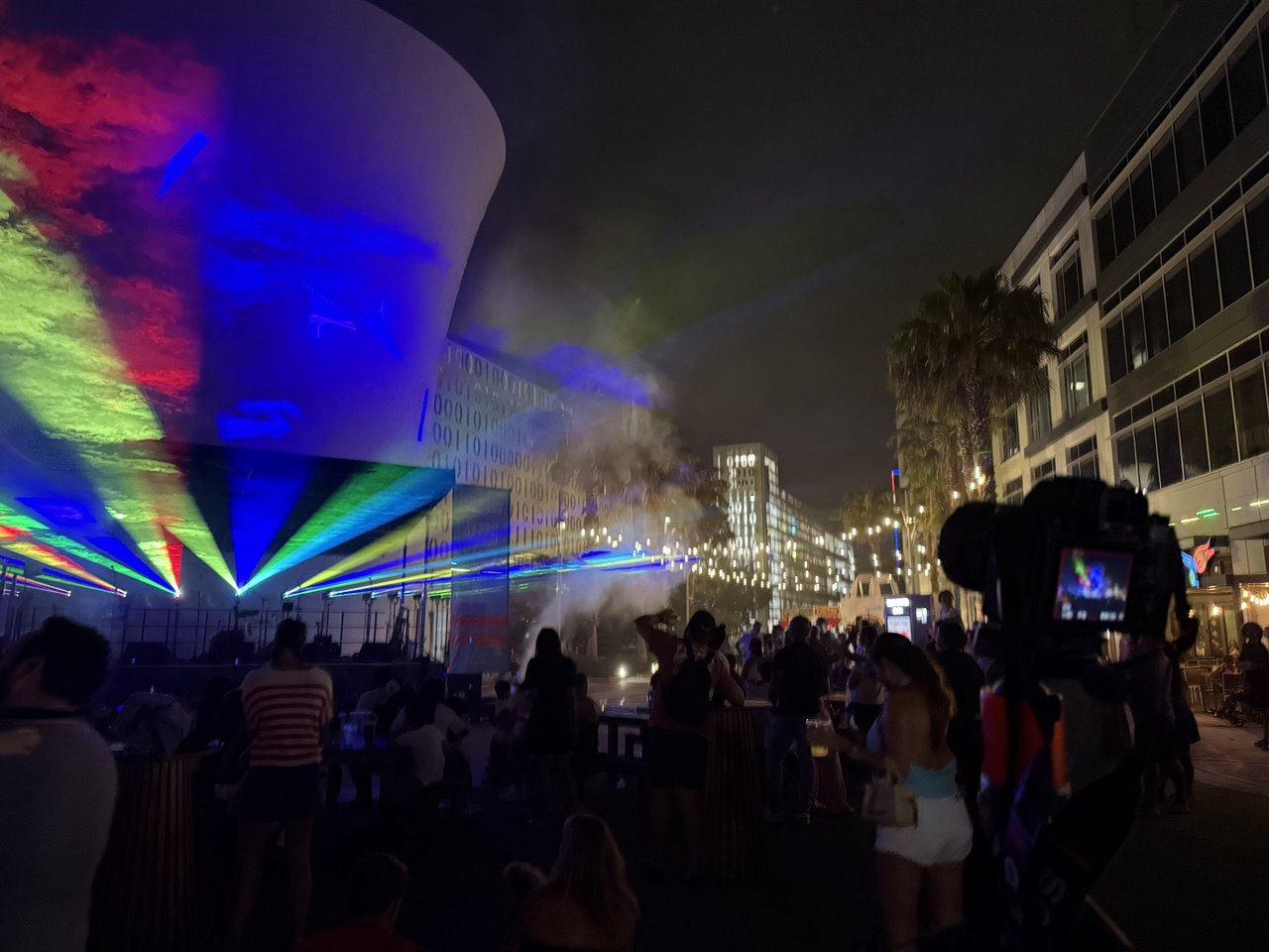 Rainbow laser beams painting the Beacon. camera crew capturing the show
