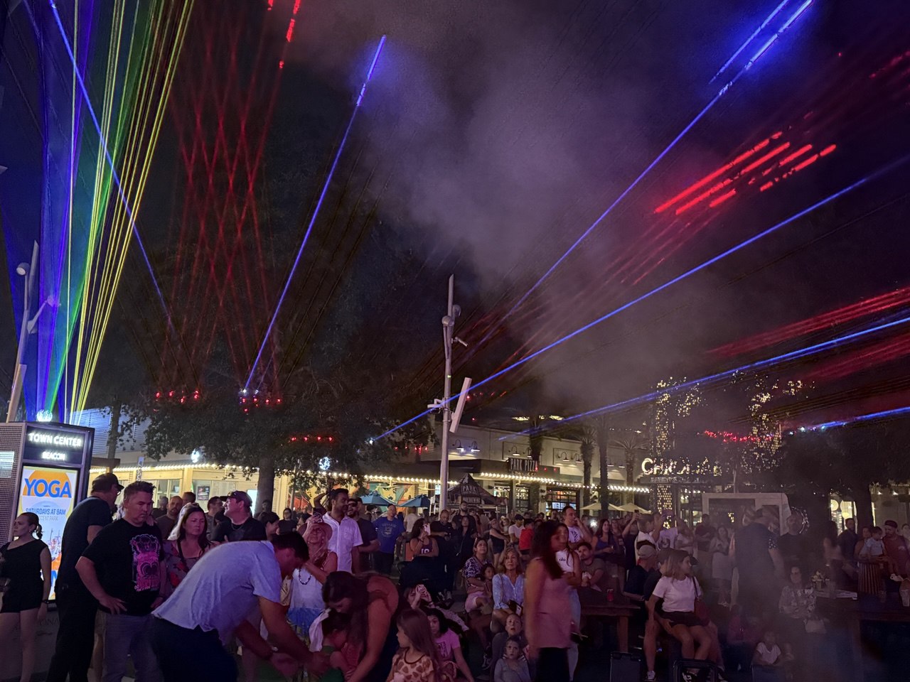 Lake Nona laser art installation with multicolor beams over crowd