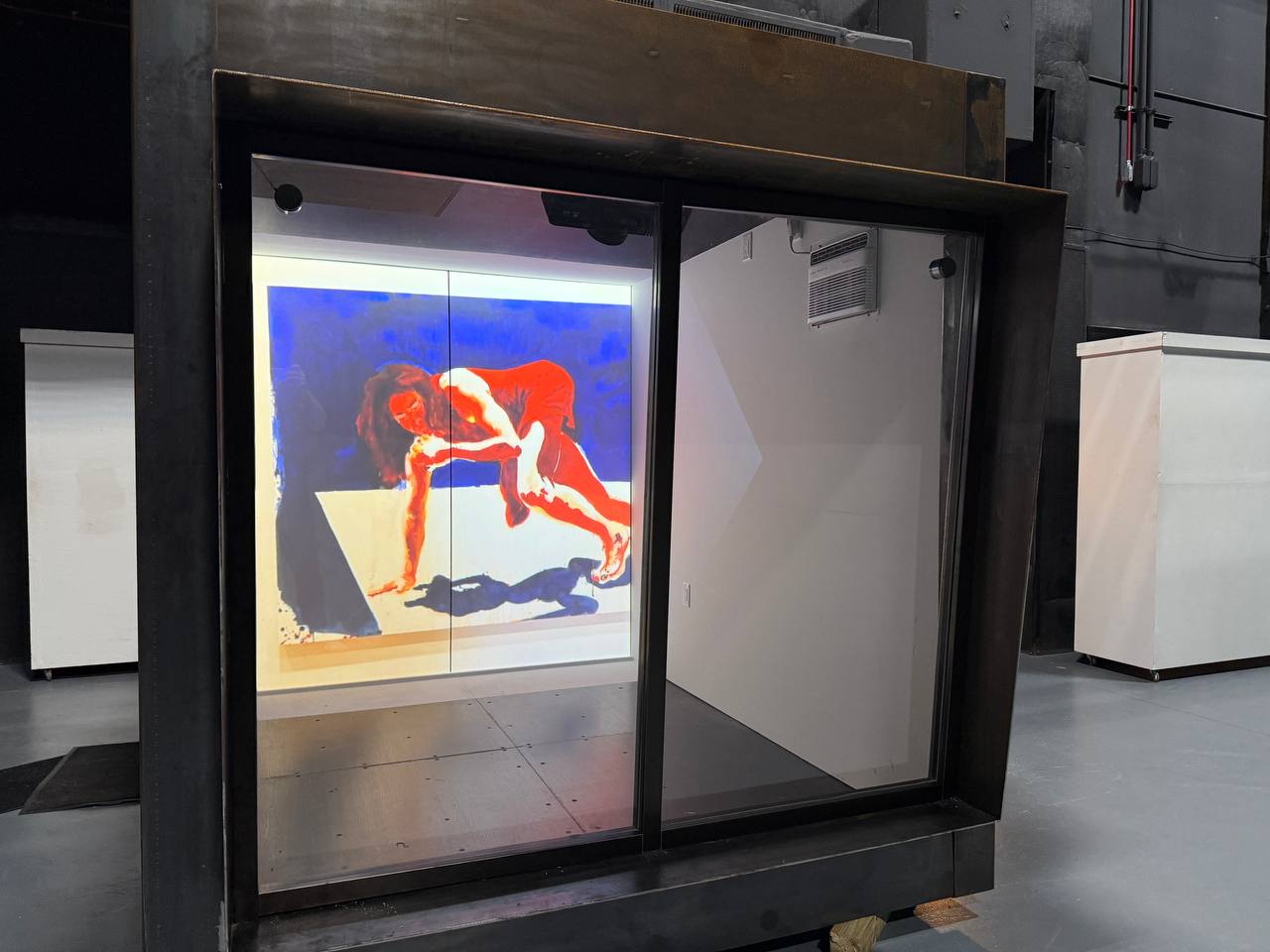 Bold red and blue figurative painting projected inside ArtCube