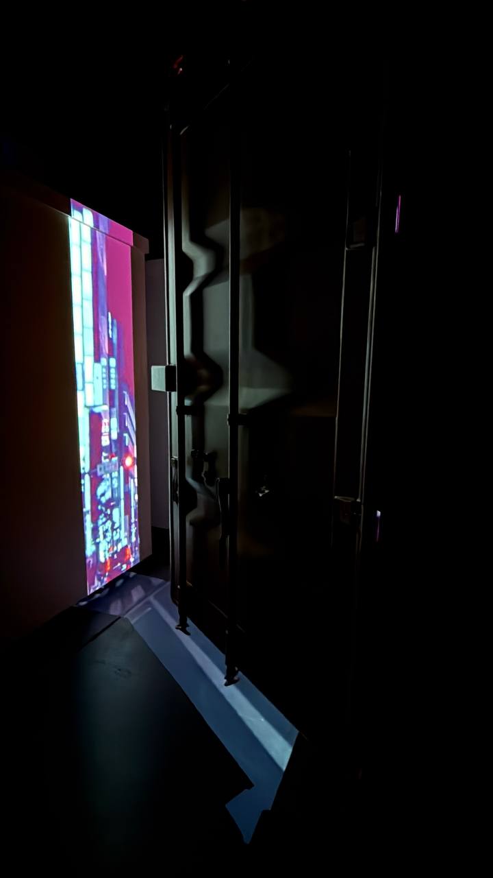 Magenta urban cityscape glowing from vertical screen inside ArtCube