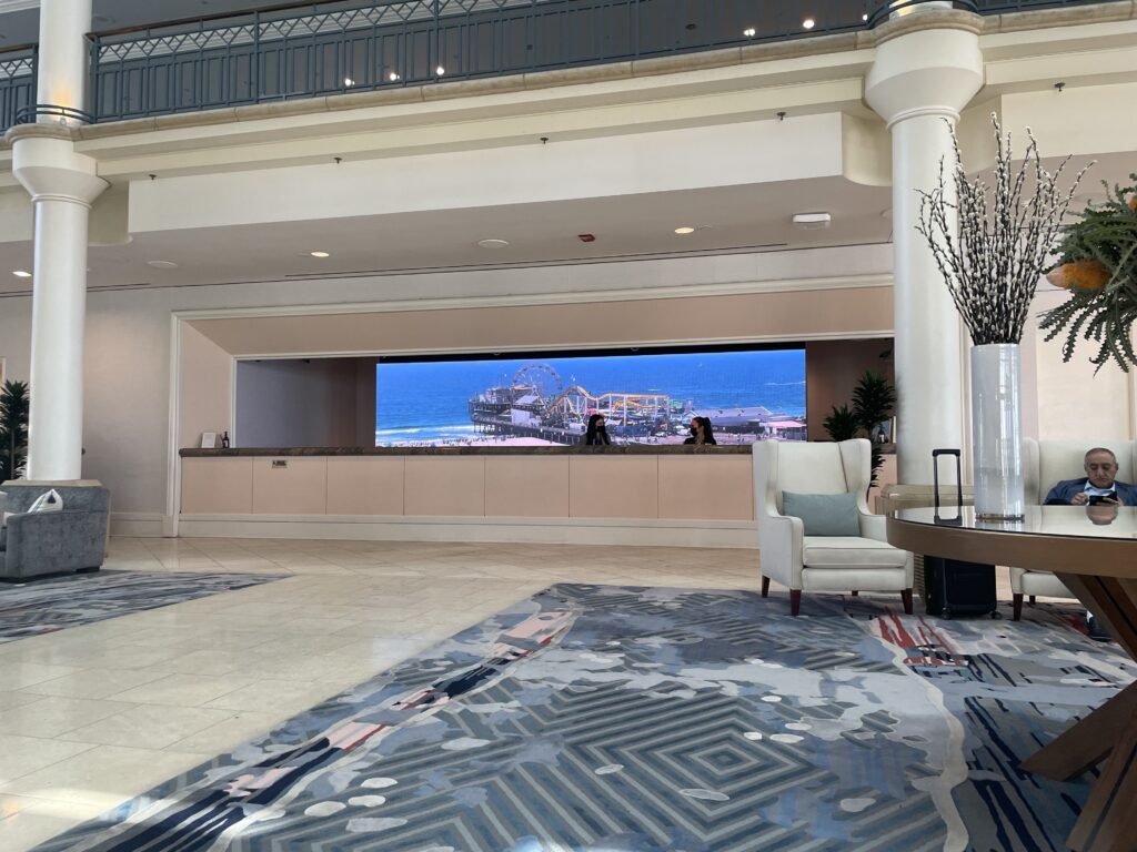 Hotel lobby LED video wall displaying Santa Monica Pier